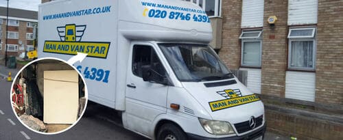 The image shows a white man and van vehicle parked outside a residential building possibly in Streatham Hill, SW2, with the company's branding and contact details on the sides. The van is positioned on a street next to a brick apartment block, with the driver's side facing the camera. In the foreground, the rear of the van is partially visible, showing a glimpse of the cargo area. The van's front is slightly angled toward the right, and the environment appears to be a typical UK urban residential street. The scene suggests readiness for a house removal or relocation service, with the branded vehicle indicating professional removals work by Man and Van Star. The background features a multi-story residential building with brick walls, windows, and a small outdoor light fixture, consistent with typical Streatham Hill local architecture. The weather appears clear, and there is natural daylight illuminating the street and vehicle, emphasizing the professional and functional aspect of the removals service.